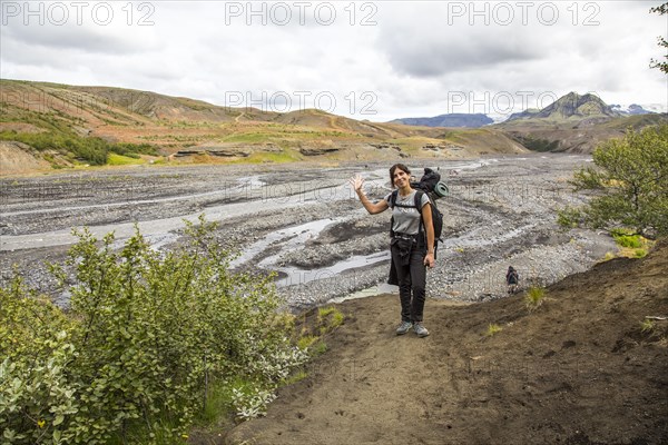 A young woman arriving at some cold rivers on the 4-day trek from Landmannalaugar. Iceland