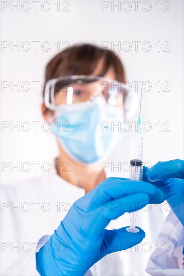Coronavirus vaccine in the hands of a young female doctor