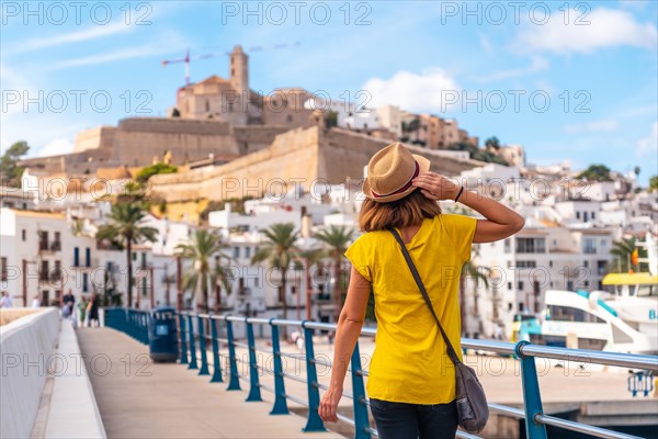 A young woman on spring vacation in Ibiza town next to the lighthouse