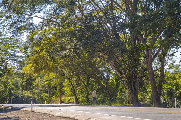 A local cyclist with a hat on the roads of Copan Ruinas. Honduras