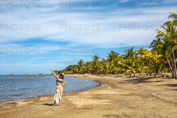 A young tourist on the beach of Sandy Bay on Roatan Island. Honduras