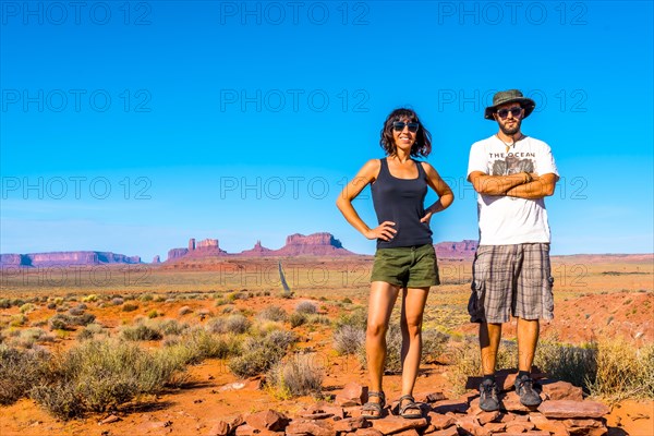 A couple looking at the point where the famous Forrest Gum movie was recorded in Monument Valley