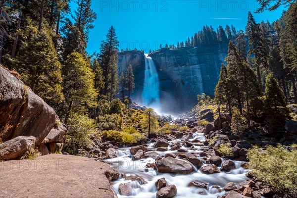 Landscape of Vernal Falls from the bottom one summer morning and the sun above. California