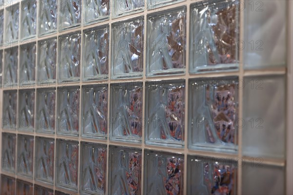 Thick glass block wall background at the expo. Mid shot