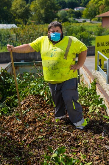 Worker in a recycling factory or clean point and garbage with a face mask and with security protections