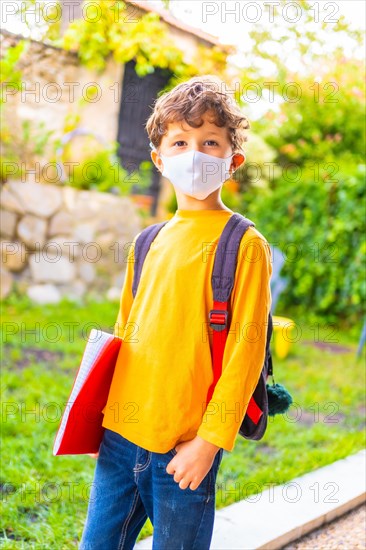 Caucasian child with face mask ready for back to school. New normality