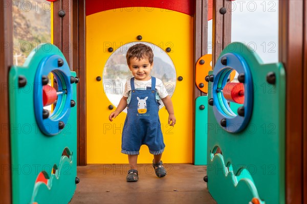 Boy playing in a playground having fun in summer