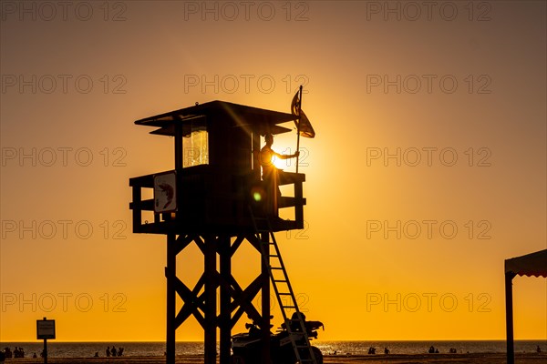 A watchman working in the summer at the Watchman's Post at sunset on the Bateles beach in Conil de la Frontera