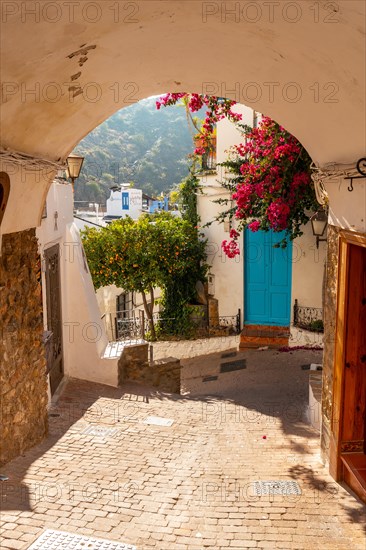 The city gate of Mojacar with white houses on top of the mountain. Costa Blanca in the Mediterranean Sea