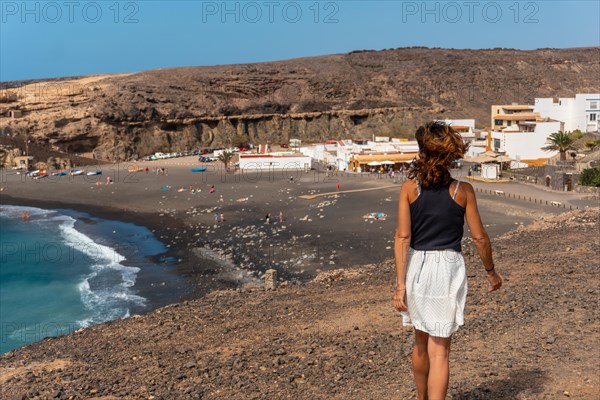 A young tourist girl on vacation on the beach of Ajuy