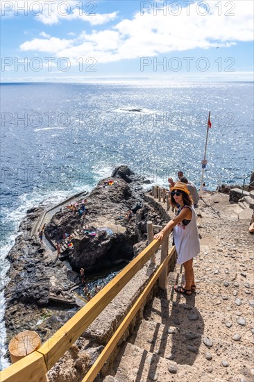 A young tourist descending the stairs to reach the cove of Puerto de Puntagorda