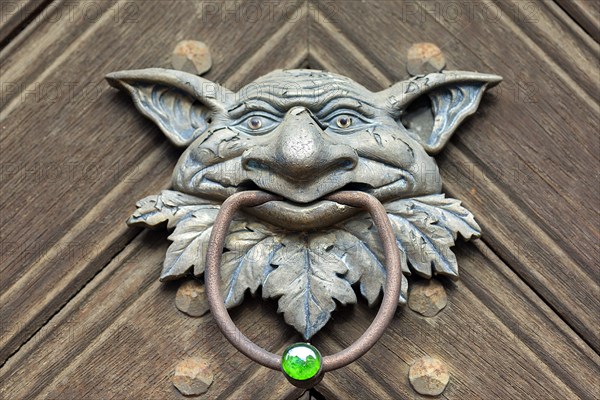 Grotesque as a door knocker on a front door