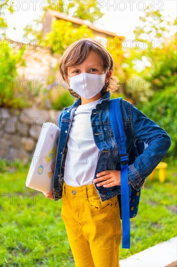 Caucasian child with face mask ready for back to school. New normality