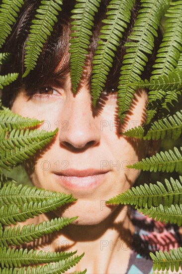 Portrait of a young girl on ferns in nature. Listorreta Natural Park in the town of Errenteria in the Penas de Aya or Aiako Harria park. Gipuzkoa