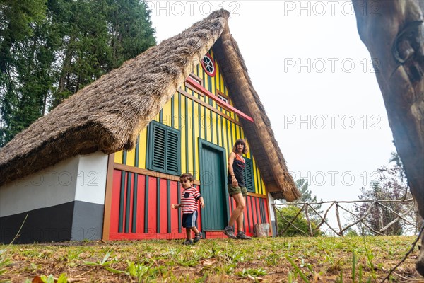 Mother and son playing in a traditional Madeiran house like the ones in Santana in the forest of Caldeirao Verde