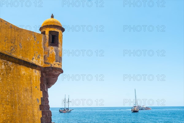 Yellow watchtower at the Forte de Sao Tiago on the beach of Funchal. Madeira