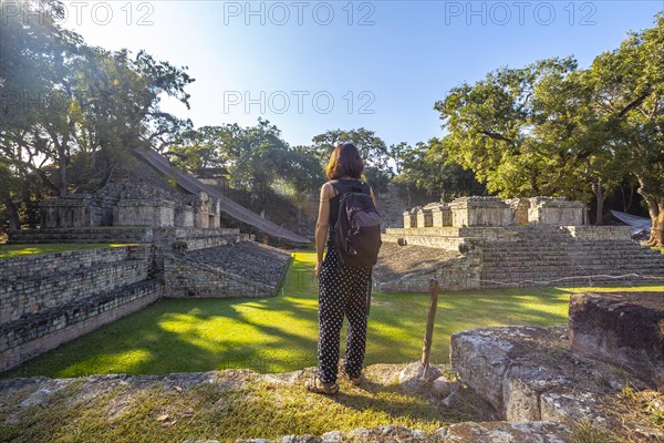 A young girl watching The ball game field in the temples of Copan Ruinas. Honduras