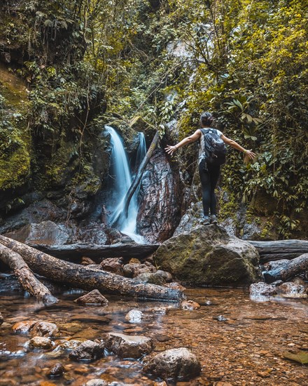 A young woman enjoying the natural waterfall of the Cerro Azul Meambar National Park