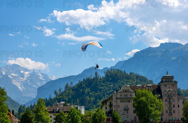 Paragliding in Front Of Snow Capped Jungfraujoch Mountain in a Sunny Day in Interlaken