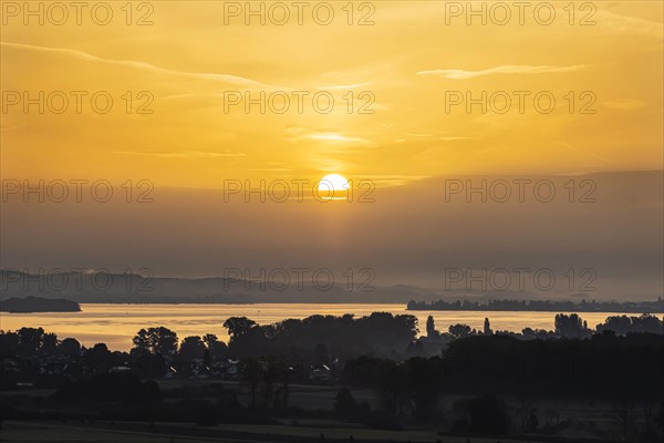 Sunrise at Lake Constance nature reserve Zeller Aachried with autumn fog