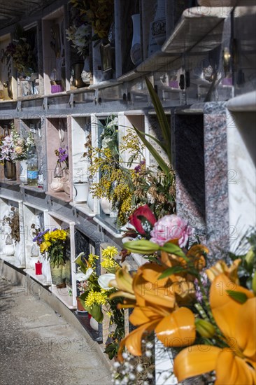 Wall with decorated urns graves in a cemetery in Sardinia