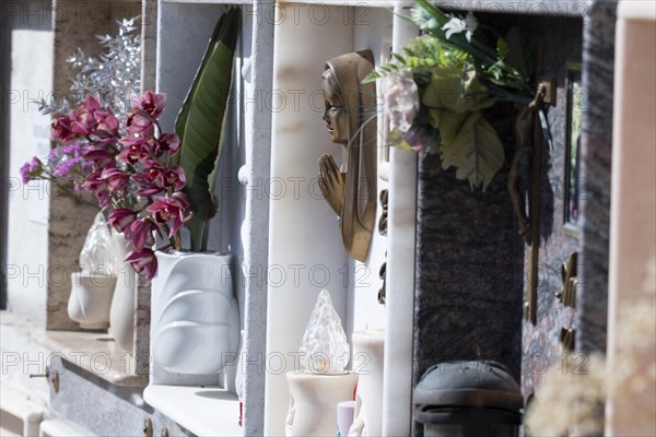 Wall with decorated urns graves in a cemetery in Sardinia