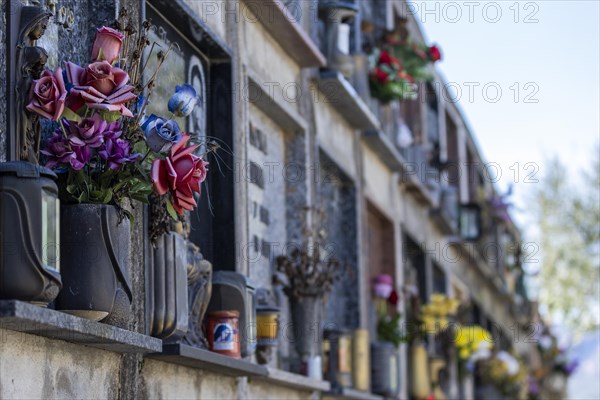 Wall with decorated urns graves in a cemetery in Sardinia