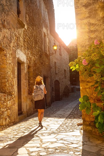 A young tourist walking in Pals medieval town