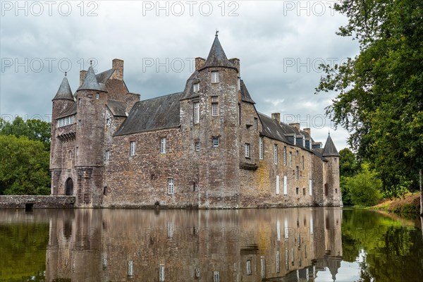 Reflections of the medieval Chateau Trecesson in the lake