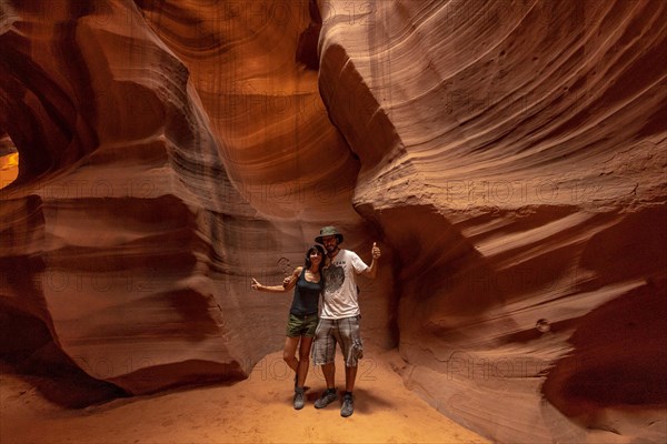 A couple admiring the beauty of the Upper Antelope Canyon in the town of Page