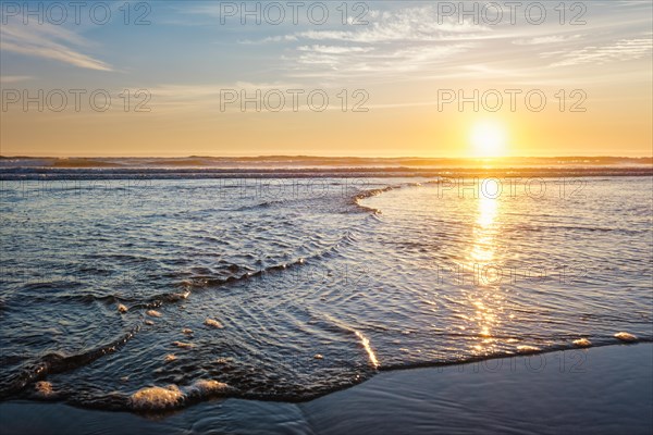 Atlantic ocean sunset with surging waves at Fonte da Telha beach