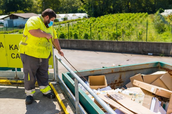 Worker in a recycling factory or clean point and garbage with a face mask and with security protections