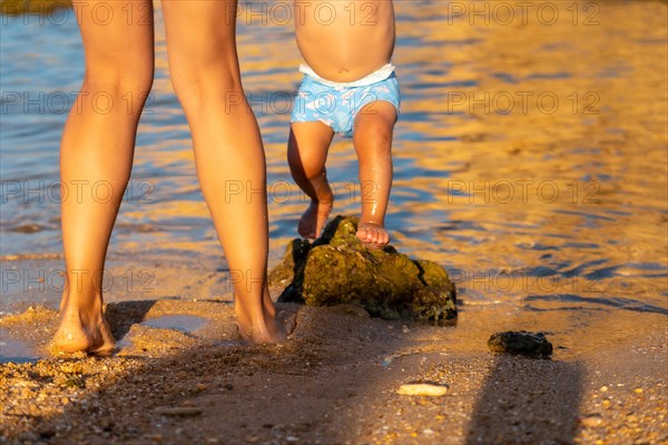 Playing with her baby in summer at Praia dos Arrifes