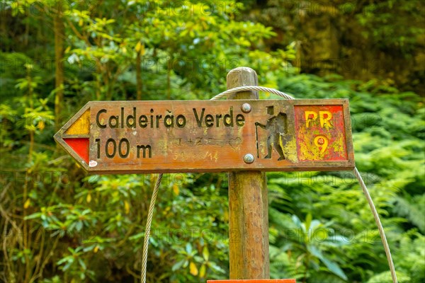 Signs on the trekking trail next to the waterfall in Levada do Caldeirao Verde