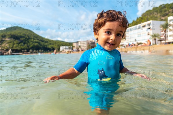 One year old boy bathing in the sea