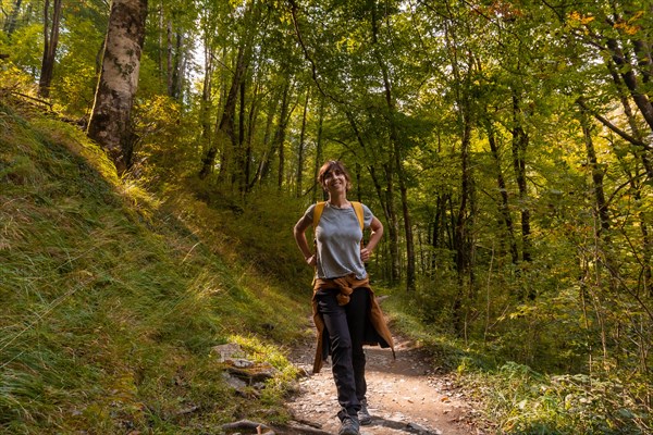 A young woman heading to Passerelle de Holtzarte de Larrau in the forest or jungle of Irati
