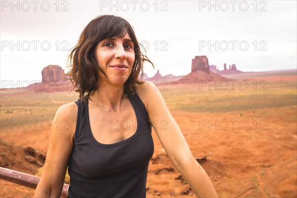 A young woman looking in a cloudy Monument Valley National Park. Utah