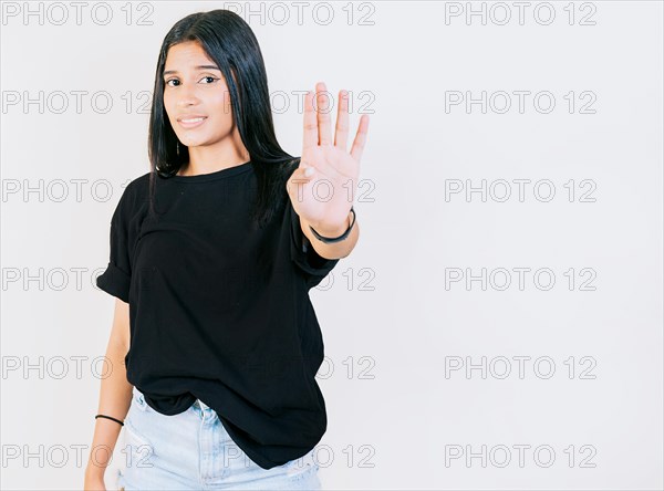 Teen girl gesturing stop with palm hand isolated. Young woman rejecting with the palm of hand isolated. People gesturing stop isolated