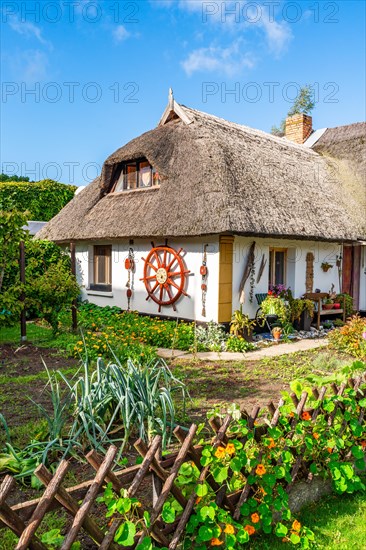 Garden and thatched house in the fishing village of Wieck