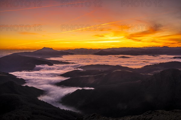 Detail of the beautiful fog between the mountains of the Basque country next to Mount Larrun in the golden hour