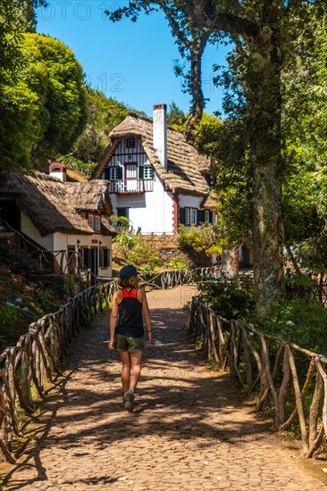 A young woman walking at the start of Levada do Caldeirao Verde