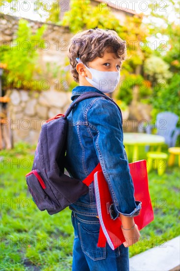 Caucasian child with face mask ready for back to school. New normality