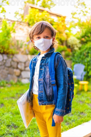 Caucasian child with face mask ready for back to school. New normality