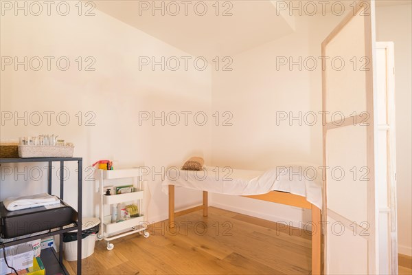 Interior room with a massage stretcher in a simple and cute space