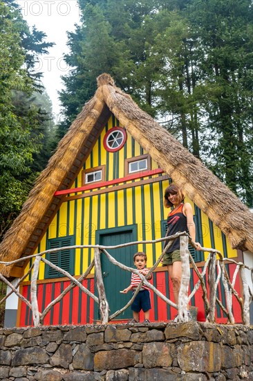 Mother and son in a Madeiran house like those of Santana in the forest of Caldeirao Verde