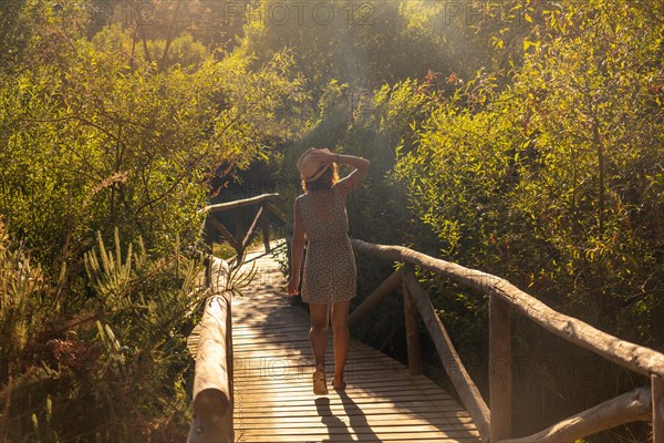 A young tourist on a wooden walkway in the Donana Natural Park