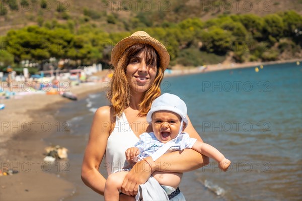 Mother with her baby in Cala Montjoi