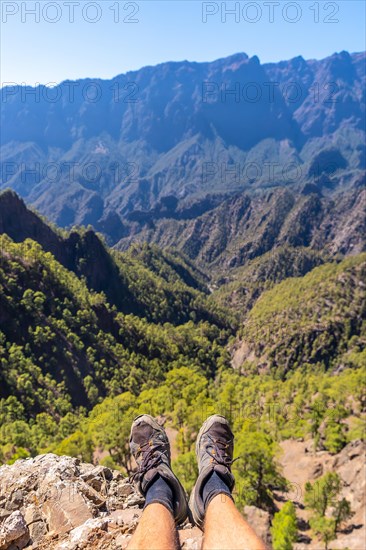Feet of a young man resting after trekking on top of La Cumbrecita in the high mountains of La Palma island