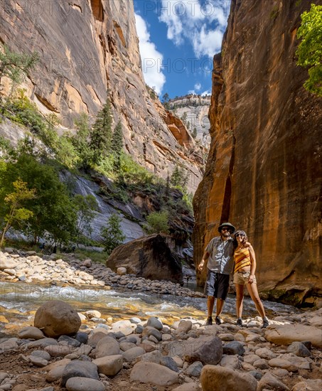 A young couple in the Interior of the Zion national park canyon. United States