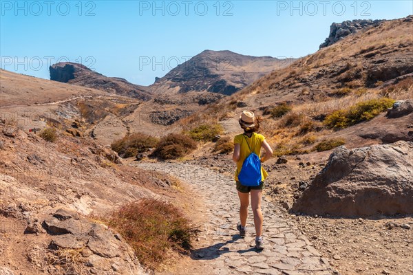 A young woman on a trekking trail in Ponta de Sao Lourenco